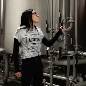 A Uinta employee turns a lever in the Brewhouse