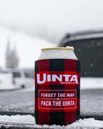 Load image into Gallery viewer, A beer can in a plaid beer Koozie, resting on a tailgate in the snow
